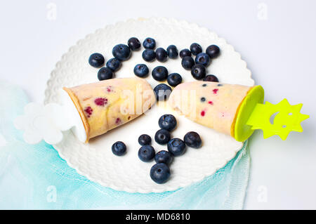 Blueberry fruit popsicles with fresh berries on the plate Stock Photo