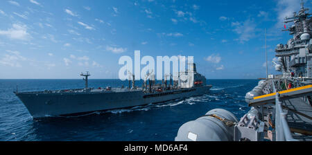 180329-N-BD308-0019 PHILIPPINE SEA (March 29, 2018) The amphibious assault ship USS Wasp (LHD 1) conducts a replenishment-at-sea with the fleet replenishment oiler USNS Tippecanoe (T-AO 199). Wasp, part of the Wasp Expeditionary Strike Group, with embarked 31st Marine Expeditionary Unit, is operating in the Indo-Pacific region to enhance interoperability with partners, serve as a ready-response force for any type of contingency and advance the Up-Gunned ESG Concept. (U.S. Navy photo by Mass Communication Specialist 3rd Class Levingston Lewis/Released) Stock Photo