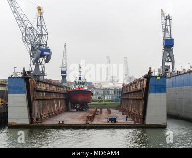 Rotterdam, Netherlands - 20 July 2015: a vessel inside the lifted dry dock of a shipyard at Europort Rotterdam. Stock Photo