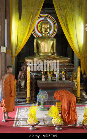 Cambodia monks - two buddhist monks meditating in a buddhist temple interior, Siem Rep town, Cambodia South East Asia Stock Photo