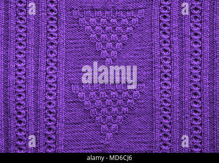 Ultraviolet texture of knitted handmade. Close up. Wallpaper or abstract background. Pattern. Stock Photo