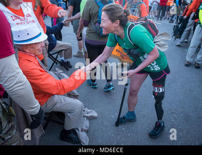 A participant in the 2018 Bataan Memorial Death March greets 100-year-old Bataan Death March survivor Col. Ben Skardon, a beloved Clemson University alumnus and professor emeritus, at the beginning of the race at White Sands Missile Range, N.M., March 25, 2018. (Photo by Ken Scar) Stock Photo