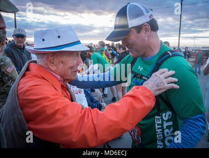 Former Navy Special Operations Master Chief Harold Bologna (left) embraces retired U.S. Army Col. and Bataan Death March Survivor Ben Skardon, 100, at the beginning of the Bataan Memorial Death March at White Sands Missile Range, N.M., March 25, 2018. Bologna is a double amputee who first met Skardon when they were both walking in the march in 2016. (Photo by Ken Scar) Stock Photo