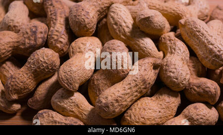 Close up of raw unshelled natural peanuts in the shells. Stock Photo