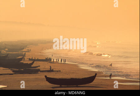Kerala, India; fishing boats on the beach at dawn. Traditional fishing in Kerala is increasingly threatened by factory fishing. Stock Photo