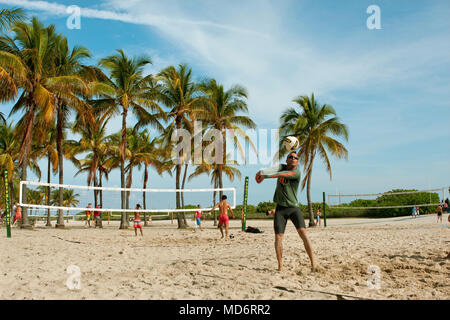 People play pickup games of beach volleyball on a public beach off Ocean Drive on December 27, 2014 in Miami, FL. Stock Photo