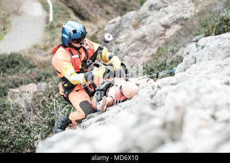 An Aviation Survival Technician Is Lowered From An MH-60 Jayhawk ...