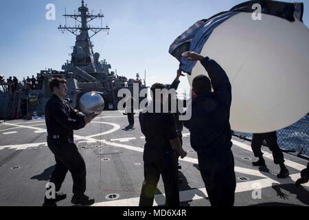 180330-N-KP946-258 MEDITERRANEAN SEA  (March 30, 2018) Sailors release a weather balloon for a radar calibration maintenance check aboard the Arleigh Burke-class guided-missile destroyer USS Donald Cook (DDG 75) March 30, 2018.  Donald Cook, forward-deployed to Rota, Spain, is on its seventh patrol in the U.S. 6th Fleet area of operations in support of regional allies and partners, and U.S. national security interests in Europe and Africa. (U.S. Navy photo by Mass Communication Specialist 2nd Class Alyssa Weeks / Released) Stock Photo