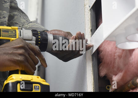 50th Space Wing is a United States Air Force unit responsible for space and satellite operations, headquartered at Schriever Air Force Base, Colorado. On March 29, 2018, the vice commander assisted 50th Civil Engineering Squadron personnel with plumbing tasks in an outdoor recreation warehouse, using tools and installing polyvinyl chloride piping. The archival image documents hands-on maintenance support within the base facility. Stock Photo