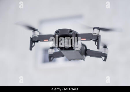 Pancevo - Serbia 03.01.2018. DJI Mavic Air drone flying mid air on cloudy day with blured gray house in background. Smallest foldable drone  with 4K c Stock Photo