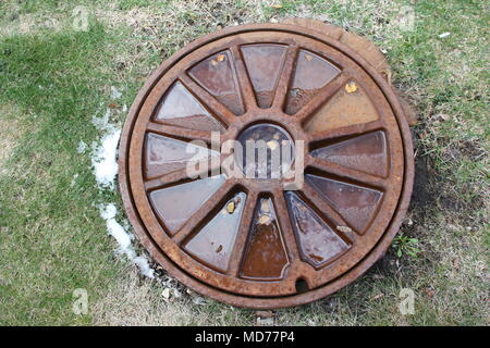 Decorative manhole cover for access to underground utilities. Stock Photo