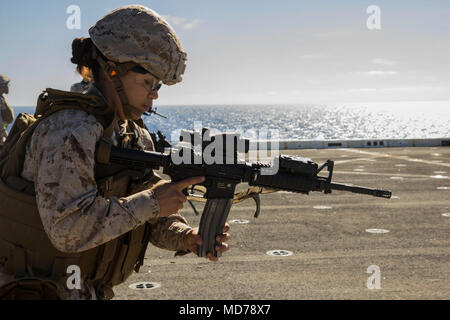 MEDITERRANEAN SEA (March 30, 2018) Marine Corps Sgt. Daneth Cueto , an embark specialist assigned to Combat Logistics Battalion 26, 26th Marine Expeditionary Unit (MEU) loads her M4 carbine rifle during a deck shoot aboard San Antonio-class amphibious transport dock USS New York (LPD 21) March 30, 2018. The MEU maintains a constant state of readiness by doing routine weapons familiarization and deck shoots while deployed to U.S. 6th Fleet area of operations. U.S. 6th Fleet, headquartered in Naples, Italy, conducts the full spectrum of joint and naval operations, often in concert with allied an Stock Photo