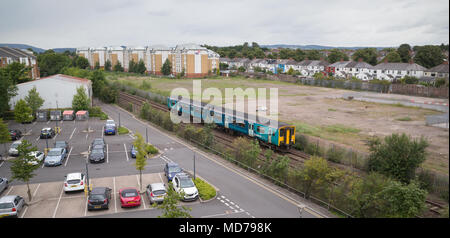 Class 150 diesel train on Arriva Trains Wales service to Bridgend passing car park of Cardiff University north of Cathays station Stock Photo