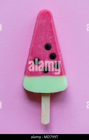 Watermelon shaped summer ice lolly on a pastel pink background Stock Photo