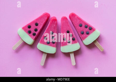 Watermelon shaped summer ice lolly on a pastel pink background Stock Photo