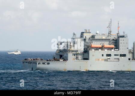 180328-N-DL434-165 PHILIPPINE SEA (March 29, 2018) An SA-330 Puma helicopter approaches the dry cargo and ammunition ship USNS Wally Schirra (T-AKE 8) during a replenishment-at-sea with the Wasp Expeditionary Strike Group (ESG). The Wasp ESG is operating in the Indo-Pacific region as part of a regularly scheduled patrol and provides a rapid-response capability in the event of a regional contingency or natural disaster. (U.S. Navy photo by Mass Communication Specialist Seaman Gavin Shields/Released) Stock Photo