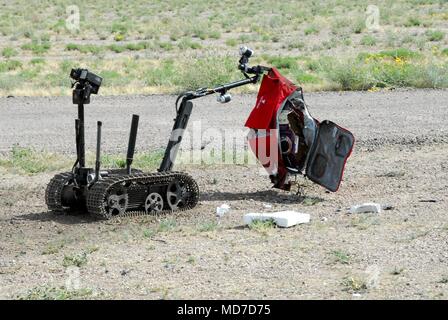 A TALON explosive ordnance disposal robot is remotely controlled by an EOD technician from the 71st Ordnance Group (EOD) to move a suspected exercise improvised explosive device to an area where it can be rendered safe at Pinal Air Park, Ariz. during Raven’s Challenge XII, March 19-23. The Raven’s Challenge Exercise is an annual, interagency, counter IED exercise that incorporates scenarios focused on interoperability capabilities between public safety bomb squads (PSBSs) and military EOD units in operational environments. Stock Photo