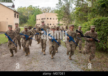Airmen from 820th Base Defense Group (BDG), run as a group following dismounted operations training, March 27, 2018, at Moody Air Force Base, Ga. The dismounted ops training is part of an Initial Qualification Training, which gives new Airmen coming into the BDG an opportunity to learn a baseline of basic combat skills that will be needed to successfully operate within a cohesive unit while in a deployed environment. (U.S. Air Force photo by Airman Eugene Oliver) Stock Photo