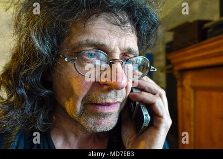 Senior man Person On phone at home Inside portrait 60s Senior calling in glasses using a mobile phone Czech senior portrait in active life Stock Photo