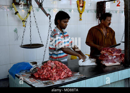 Two men working on a butchers stall in the market in Margao, near Benaulim, Goe, India Stock Photo