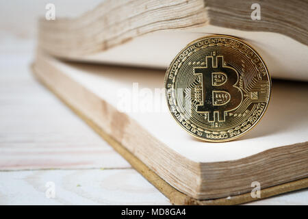 Golden bitcoin on open book electronic or digital money Stock Photo
