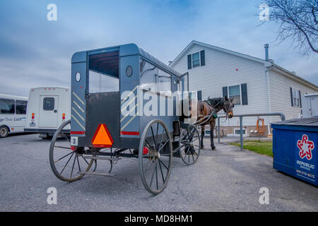 Pennsylvania, USA, APRIL, 18, 2018: View of the back of Amish buggy with a horse parked in a farm Stock Photo