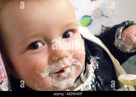 Portrait of little messy baby boy with food around mouth Stock Photo