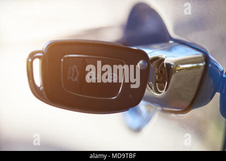 Modern car key inserted in handle macro close up Stock Photo