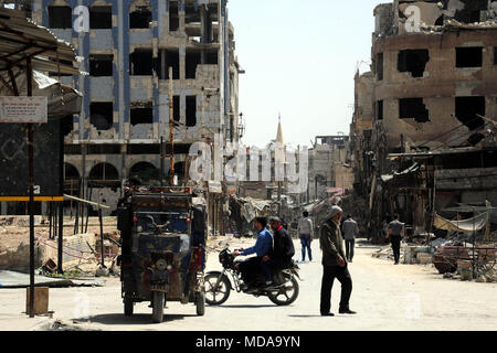 Beijing, Syria, China. 18th Apr, 2018. Syrians are seen in a street in Douma district, east of Damascus, Syria, on April 18, 2018. Credit: Ammar Safarjalani/Xinhua/Alamy Live News Stock Photo