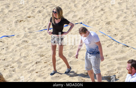 Brighton UK 19th April 2018  - Stars and extras from the reality television show 'The Only Way is Essex' enjoy  beach volleyball on Brighton seafront in the beautiful sunny weather during filming . The hot sunny weather is set to continue throughout Britain with temperatures expected to reach into the high twenties in parts of the South East Credit: Simon Dack/Alamy Live News Credit: Simon Dack/Alamy Live News Stock Photo