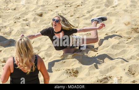 Brighton UK 19th April 2018  - Stars and extras from the reality television show 'The Only Way is Essex' enjoy  beach volleyball on Brighton seafront in the beautiful sunny weather during filming . The hot sunny weather is set to continue throughout Britain with temperatures expected to reach into the high twenties in parts of the South East Credit: Simon Dack/Alamy Live News Credit: Simon Dack/Alamy Live News Stock Photo