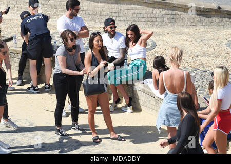 Brighton UK 19th April 2018  - Stars and extras from the reality television show 'The Only Way is Essex' enjoy  beach volleyball on Brighton seafront in the beautiful sunny weather during filming . The hot sunny weather is set to continue throughout Britain with temperatures expected to reach into the high twenties in parts of the South East Credit: Simon Dack/Alamy Live News Credit: Simon Dack/Alamy Live News Stock Photo