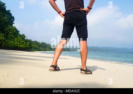 Man relaxing on exotic beach in Seychelles Islands. Man walking on beautiful exotic beach from Seychelles. Alone man walking on tropical beach. Man st Stock Photo