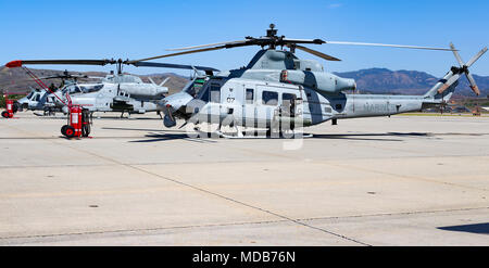 A Marine Corps UH-1Y Venom and an AH-1W Super Cobra from Marine Light Attack Helicopter Squadron 775 (HMLA 775), Marine Aircraft Group-41, 4th Marine Aircraft Wing, await regular maintenance on Marine Corps Air Station, Camp Pendleton, Calif., April 18, 2018. Also known as the “Coyotes”, HMLA 775 was reactivated on Camp Pendleton in 2016 after being decommissioned for nearly eight years. (U.S. Marine Corps photo by Cpl. Desiree King) Stock Photo