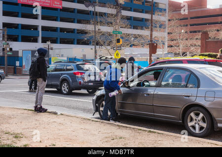 Baltimore, Maryland. Young men earn money cleaning car windows on street corner. Stock Photo