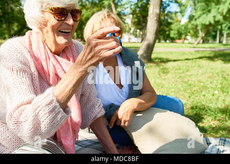 Senior Woman Playing with Fidget Spinner Stock Photo