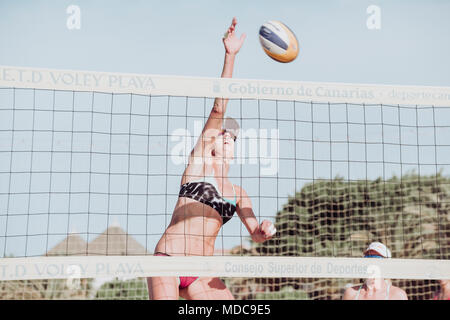 Female beach volley player in action, Los Cristianos, Tenerife, Spain Stock Photo