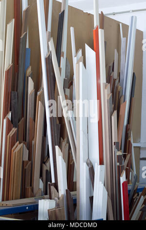 Furniture accessories. Colorful wooden floor for home renovation. Manufacture of skirting boards in a furniture factory. Stock Photo