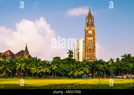 The Rajabai Clock Tower is a clock tower in South Mumbai India. It is near the Oval Maidan and Bombay High Court Stock Photo