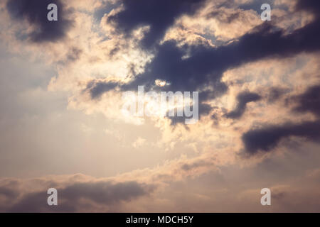 Sky cloud gray tone. the sun shines through the feathery clouds in the blue sky retro toning. Stock Photo