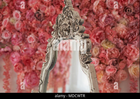 Element of old wooden carved frame on mirror.Bright interior.White frame with the effect of aging Stock Photo