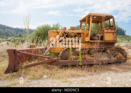 An old rusty Bulldozer abandoned in a field Stock Photo