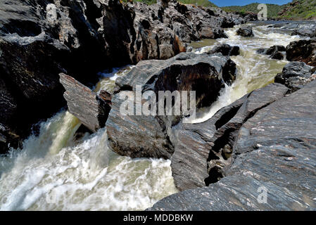 Wild waterfall in  rocky valley Stock Photo