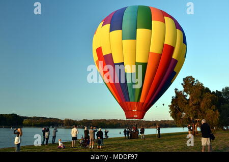 Canberra, Australia - March 11, 2018. Big colourful hot air balloon landed at Lake Burley Griffin, as part of the Balloon Spectacular Festival. Stock Photo