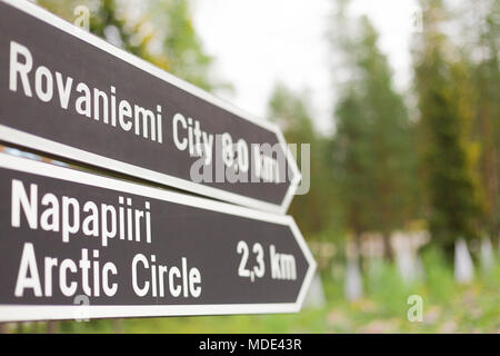 Roadsign for the Arctic Circle and Rovaniemi City Stock Photo