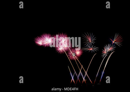 Bright and colorful fireworks against a black night sky.Fireworks for new year. Beautiful colorful fireworks display on the urban lake for celebration Stock Photo