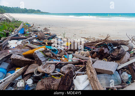 Pollution on the beach of tropical sea. Plastic garbage, foam, wood and dirty waste on beach in summer day. Stock Photo