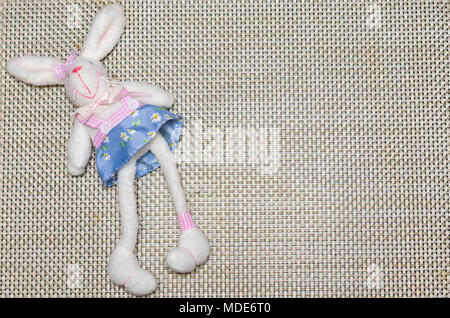 Concept of Easter, plush Easter bunny on straw background with decored. Stock Photo