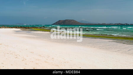 Empty beach with some rocks near Corralejo in Fuerteventura, Spain, the Isla de Lobos in the background. Stock Photo