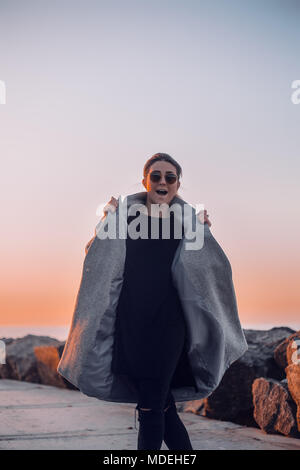 Portrait of woman wearing sunglasses and winter coat posing for camera, Odessa, Odeska Oblast, Ukraine, Eastern Europe Stock Photo